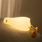 Light bulb-shaped lamp with a snail design on a textured surface